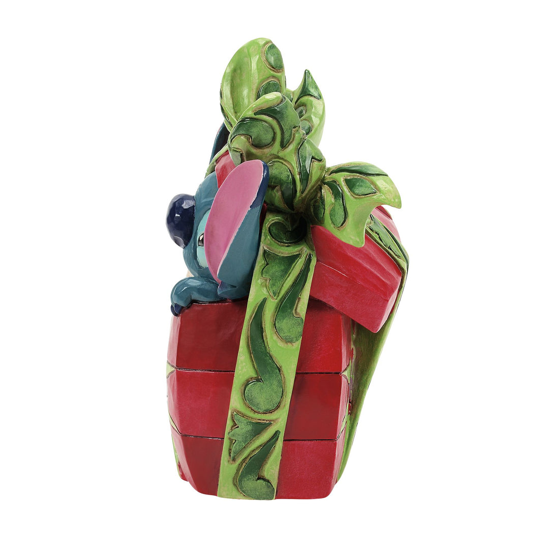 Stitch bursting from a Christmas present figurine angled view
