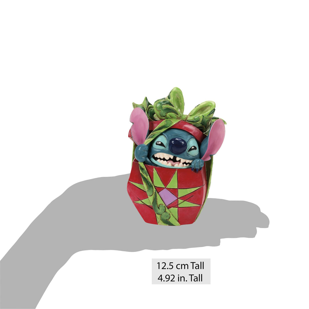 Jim Shore Stitch Tearing Present figurine rear view